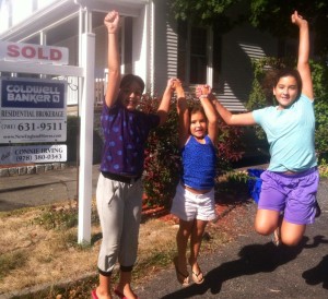 pics of kids in front of sold sign